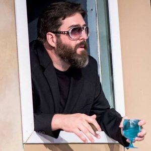 Chris popping out of a window in a production of Taming of the Shrew